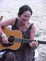 Keri Moore playing guitar at Kerrville Folk Festival campfire